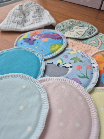 Collection of colorful breast pads with various patterns on a wooden surface.