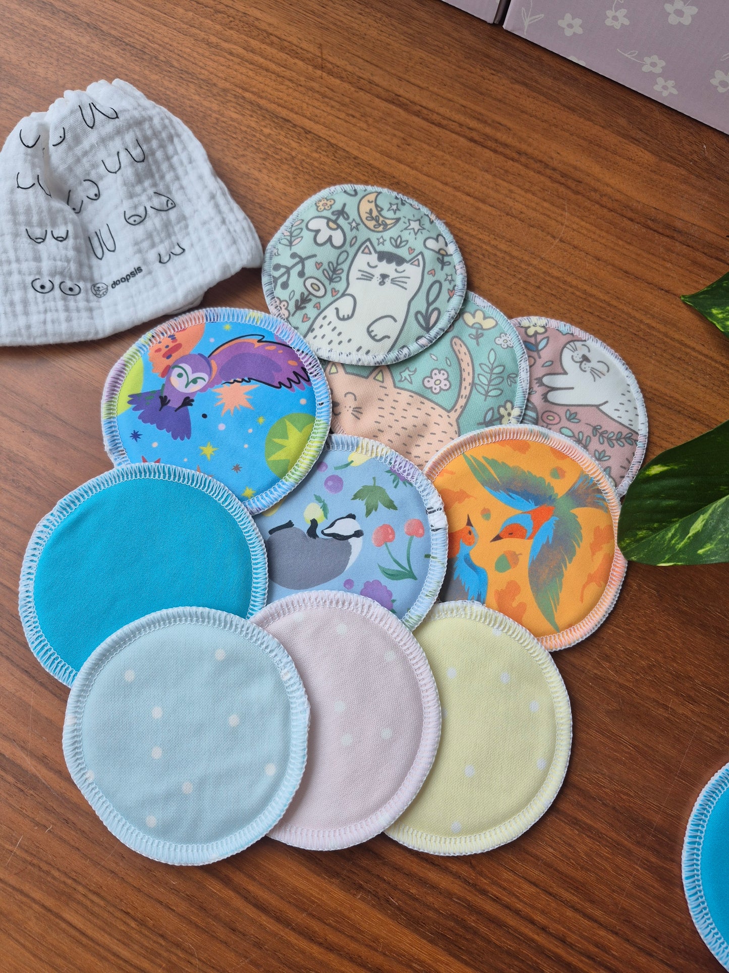 Collection of colorful breast pads on a wooden surface