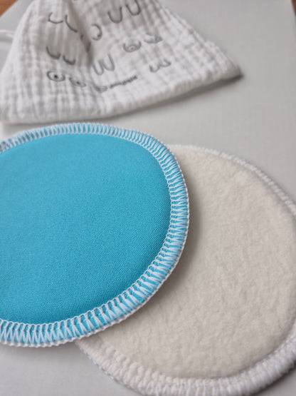 Blue circular nursing pads with white border on a light gray background