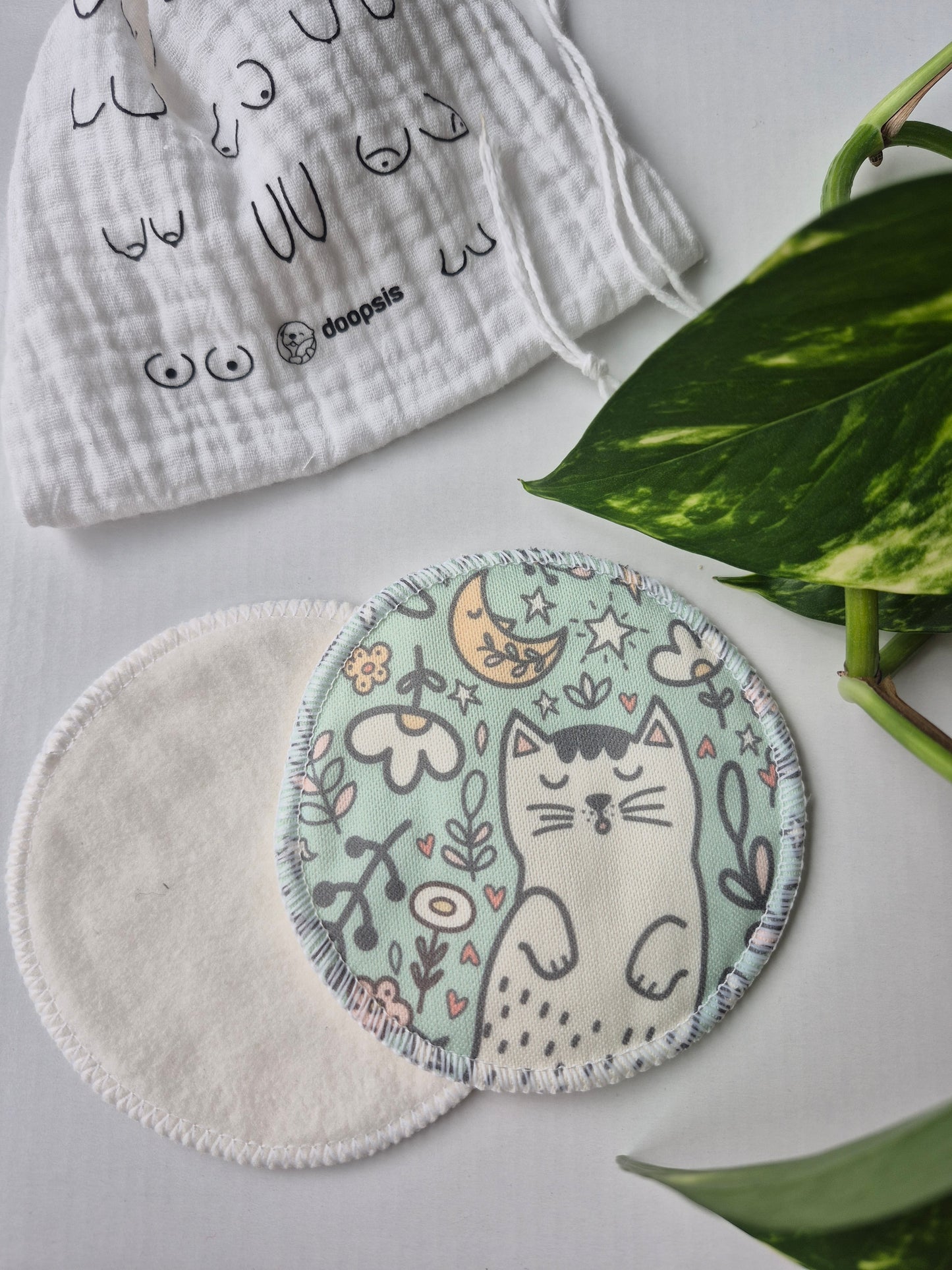 nursing pad Embroidered nuwith cat design on a white background