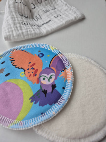 nursing pads with owl cartoon design on a light gray background